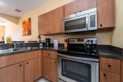 a kitchen with a microwave and a stove at 1192SBC South Beach Villa in Kissimmee