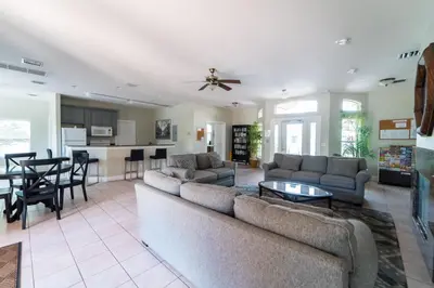 a large living room with a couch and a table at 1192SBC South Beach Villa in Kissimmee