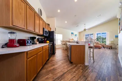 a kitchen with wooden cabinets and a kitchen island at 16813GB Fun in the Sun in Orlando