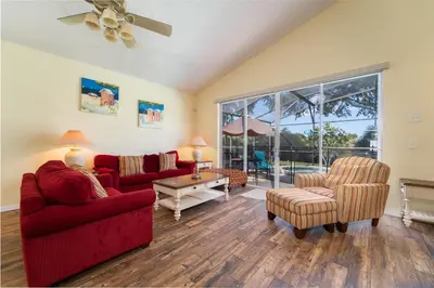 a living room with a red couch and chairs at 16813GB Fun in the Sun in Orlando