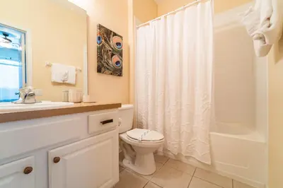 a bathroom with a toilet and a sink and a shower at WH2618DS Windsor Hills Retreat in Orlando