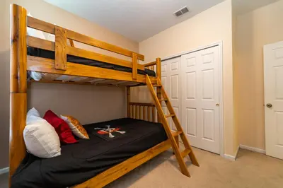 a bunk bed in a room with a ladder at WH2618DS Windsor Hills Retreat in Orlando