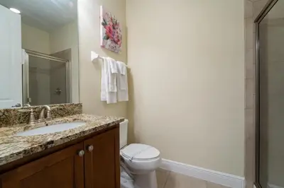 a bathroom with a toilet and a sink and a shower at 360LD Encore Magic Villa in Orlando