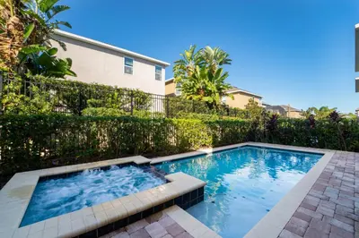 a swimming pool in front of a fence at 360LD Encore Magic Villa in Orlando