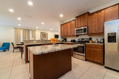 a large kitchen with wooden cabinets and a counter top at 360LD Encore Magic Villa in Orlando