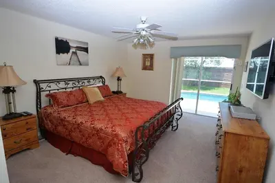a bedroom with a bed and a ceiling fan at Orlando Vacation Home Near Disney in Kissimmee