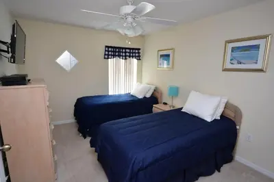 a bedroom with two beds and a ceiling fan at Orlando Vacation Home Near Disney in Kissimmee