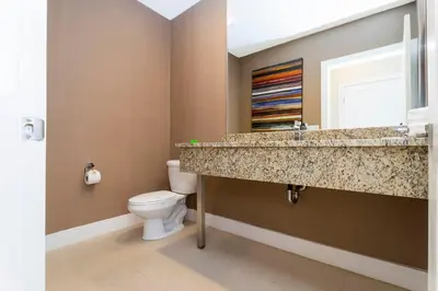 a bathroom with a sink and a toilet at Marvelous 4 Bd Close to Disney @ Magic Village 3153 in Orlando