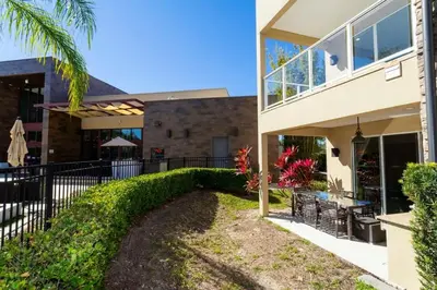 a house with a fence in front of it at Marvelous 4 Bd Close to Disney @ Magic Village 3153 in Orlando