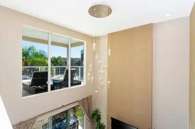 a room with a large window and a living room at Marvelous 4 Bd Close to Disney @ Magic Village 3153 in Orlando