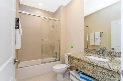 a bathroom with a shower and a toilet and a sink at Marvelous 4 Bd Close to Disney @ Magic Village 3153 in Orlando