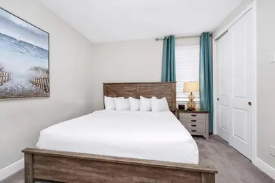 a bedroom with a white bed and a window at Spectacular Home Near Disney With Private Pool And Waterpark & Resort Access At Encore Resorts Reunion - 465Sf in Kissimmee