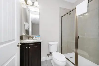 a bathroom with a toilet and a shower at Spectacular Home Near Disney With Private Pool And Waterpark & Resort Access At Encore Resorts Reunion - 465Sf in Kissimmee
