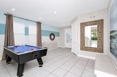 a living room with a pool table and a mirror at Spectacular Home Near Disney With Private Pool And Waterpark & Resort Access At Encore Resorts Reunion - 465Sf in Kissimmee