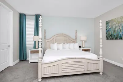 a bedroom with a white bed with white pillows at Spectacular Home Near Disney With Private Pool And Waterpark & Resort Access At Encore Resorts Reunion - 465Sf in Kissimmee