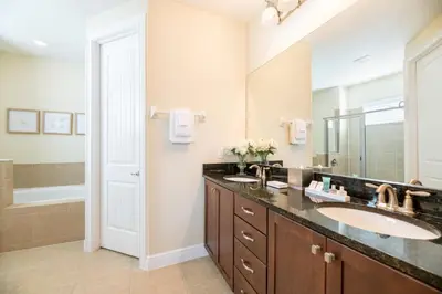 a bathroom with two sinks and a large mirror at Gorgeous Home With Media, Disney Themed Kids Room Near Disney With Waterpark & Resort Access At Encore Resort - 771La in Kissimmee