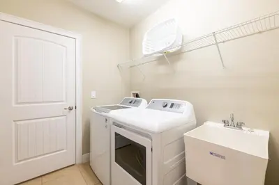 a white laundry room with a washer and dryer at Gorgeous Home With Media, Disney Themed Kids Room Near Disney With Waterpark & Resort Access At Encore Resort - 771La in Kissimmee