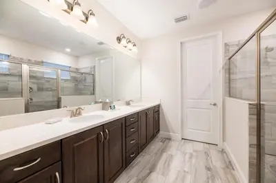a bathroom with two sinks and a mirror at Chic Home With Private Pool, Game Room And Waterpark & Resort Access Near Disney At Encore Resorts Reunion - 320Au in Kissimmee