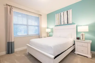 a bedroom with a white bed and a window at Chic Home With Private Pool, Game Room And Waterpark & Resort Access Near Disney At Encore Resorts Reunion - 320Au in Kissimmee