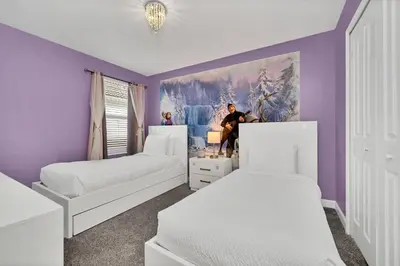 a bedroom with two beds and a painting on the wall at Gorgeous, Modern Home wPrivate Pool in Kissimmee