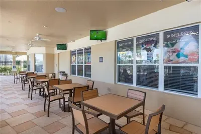 a dining room with tables and chairs and televisions at 3 BR 2 Miles to Disney, pool, free WiFi and more townhouse in Orlando
