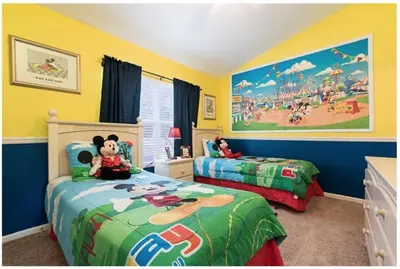 a childs bedroom with two beds and a mickey mouse mural at 3 BR 2 Miles to Disney, pool, free WiFi and more townhouse in Orlando
