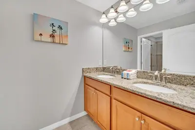 a bathroom with two sinks and a mirror at In the heart of Kissimmee Storey Lake Resort 4BD 3BA Pool Townhome 4SL4857 in Kissimmee