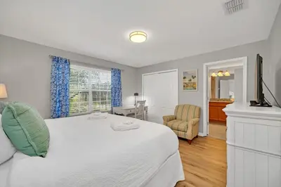 a bedroom with a large white bed and a desk at In the heart of Kissimmee Storey Lake Resort 4BD 3BA Pool Townhome 4SL4857 in Kissimmee