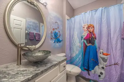 a bathroom with a mermaid shower curtain and a sink at Spacious 4BR Home Themed Rooms, Pool, Near Disney in Orlando