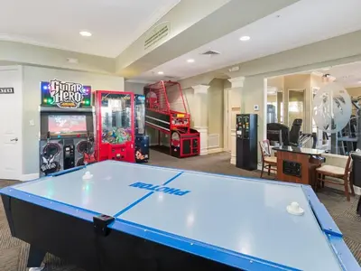 a ping pong table in a room with arcade games at Spacious 4BR Home Themed Rooms, Pool, Near Disney in Orlando