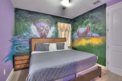 a bedroom with a painting of a bed in a room at NEW! 14BR Disney-Area Resort with Bowling & Theater in Kissimmee