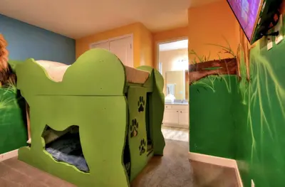 a childs room with a green elephant bunk bed at NEW! 14BR Disney-Area Resort with Bowling & Theater in Kissimmee