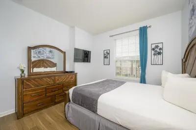 a bedroom with a bed and a mirror and a dresser at New Listing Beautiful Condo, Vista Cay - 3017 in Orlando
