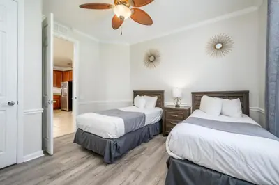 a hotel room with two beds and a ceiling fan at Epic Universe 4 Bedroom Plus, Lake View Condo, Vista Cay-1008 in Orlando