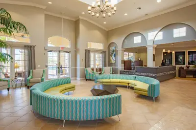a lobby with couches and tables in a building at Epic Universe 4 Bedroom Plus, Lake View Condo, Vista Cay-1008 in Orlando