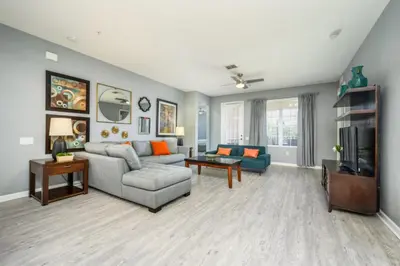 a living room with a couch and a tv at Newly Renovated Premium Condo, Vista Cay - 2002 in Orlando