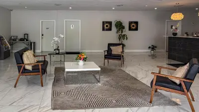 a living room with a coffee table and chairs at Motel 6 Altamonte Springs FL in Orlando
