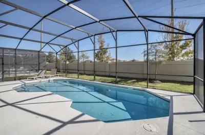 a swimming pool with a glass roof and a swimming poolvisor at American Secret 10 BED 7 Miles to Disney in Kissimmee