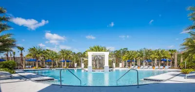 a pool at a resort with palm trees at American Secret 10 BED 7 Miles to Disney in Kissimmee