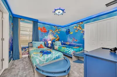 a childs room with a blue ocean themed bedroom at Storey Lake 9 BR Villa With Games Room and Theater home in Kissimmee