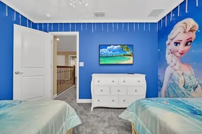 a bedroom with a mermaid painting on the wall at Storey Lake 9 BR Villa With Games Room and Theater home in Kissimmee