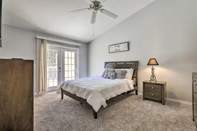 a bedroom with a bed and a ceiling fan at Less Than 8 Mi to Disney Getaway with Deck in Kissimmee! in Kissimmee