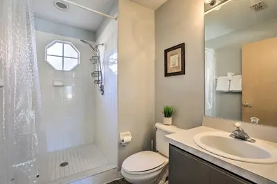 a bathroom with a sink and a toilet and a shower at Less Than 8 Mi to Disney Getaway with Deck in Kissimmee! in Kissimmee