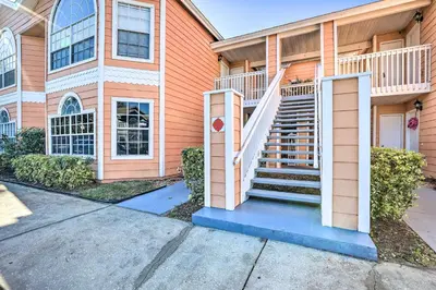 a house with stairs in front of it at Less Than 8 Mi to Disney Getaway with Deck in Kissimmee! in Kissimmee