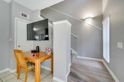 a room with a wooden table and a chair at Kissimmee Escape about 10 Mi to Disney World! in Kissimmee