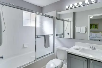 a bathroom with a shower and a toilet and a sink at Kissimmee Escape about 10 Mi to Disney World! in Kissimmee