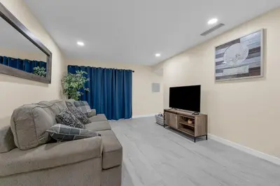 a living room with a couch and a flat screen tv at Orlando Vacational Apartment 3919 in Orlando