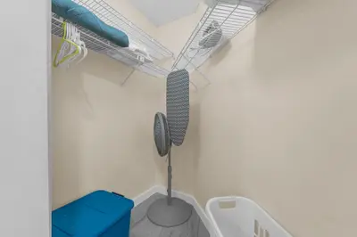 a walk in closet with a mirror and a towel rack at Orlando Vacational Apartment 3919 in Orlando