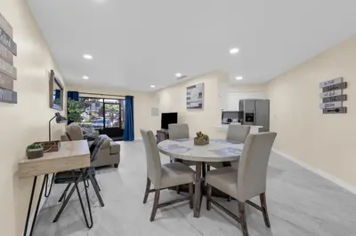 a dining room and living room with a table and chairs at Orlando Vacational Apartment 3919 in Orlando