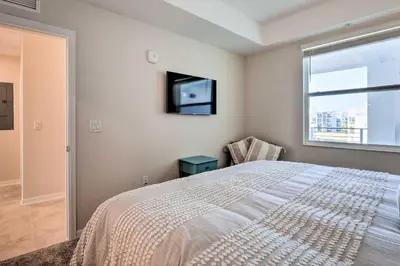 a bedroom with a bed and a tv and a window at 6 Mi to Disney Resort Hideaway with Pool Access! in Kissimmee
